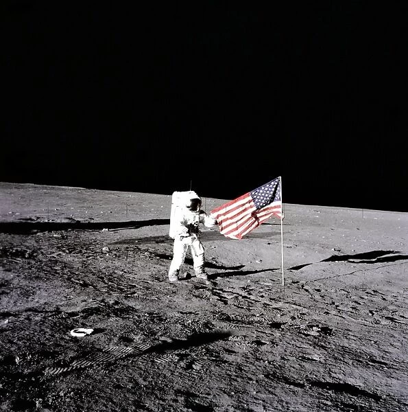 Conrad Unfurls Flag. Apollo 12 astronaut Charles 'Pete' Conrad stands beside