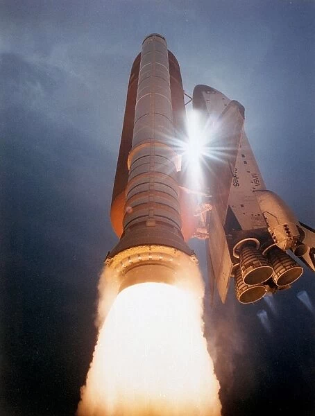 STS-43 Launch. The Space Shuttle Atlantis streaks skyward as sunlight pierces