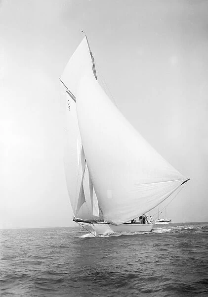 The 19-metre class Corona running downwind, 1911. Creator: Kirk & Sons of Cowes