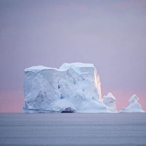 Sunset on a large iceberg at sea towards Peter I Island, Bellingshausen Sea, Antarctica, Polar Regions