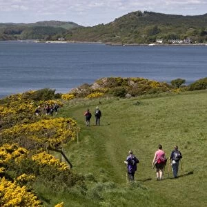 Hikers walking on coastal path, towards Rockcliffe and Kippford, Rough Firth, Solway Firth, Dumfries and Galloway