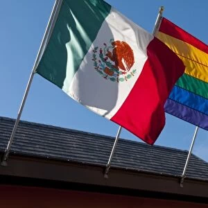 Rainbow, Mexican, and American flags on display in Castro district of San Francisco