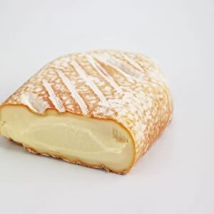 Sliced brick of French Baguette Laonnaise cows milk cheese
