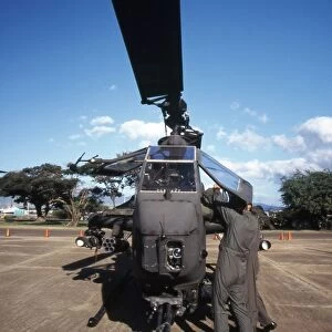 Air crewmen secure an AH-1 Cobra attack helicopter